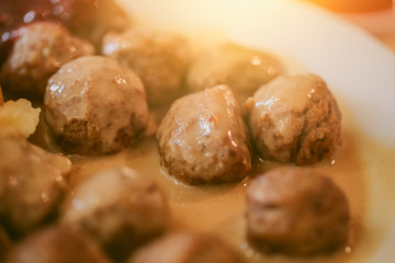 Meatballs beef in sweet cream sauce. closeup view