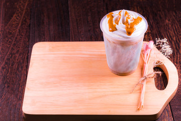 Chocolate ice cream in a cup on a grey wooden table wall background with copy space .