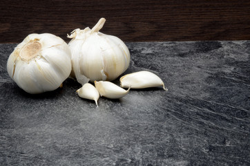 Garlic on black background close up photo