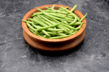 Green beans on black background close up photo