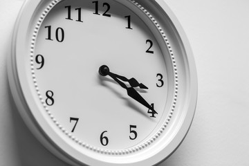 Closeup wall clock time timed at three twenty hour number vintage black and white tone.