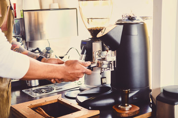 A man pouring coffee in a restaurant.