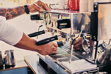 Close up image of a man preparing coffee late.