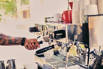 Close up image of a man preparing coffee late.