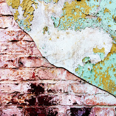 Old paint and plaster crack on a brick wall. Background. Texture.