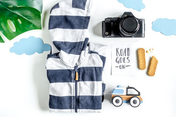 children tourism outfit with clothes and camera on white background flat lay