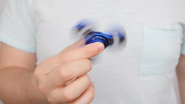 Man holding and playing with fidget spinner
