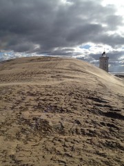 Historic lighthouse in the dunes in Denmark