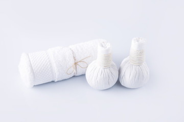 White towel and herbal balls on a white background