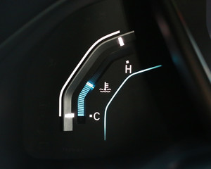 Digital temperature gauge in car dashboard.