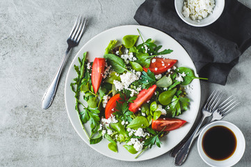 Fresh tomato salad in a grey ceramic plate. Diet or clean eating concept