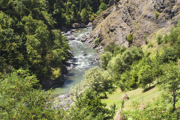 Fototapeta na wymiar The river flows in a mountain gorge