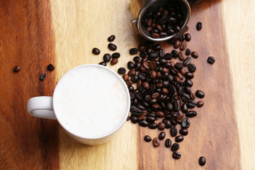 Hot latte , hot coffee and milk foam on wood floor