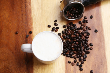 Hot latte , hot coffee and milk foam on wood floor