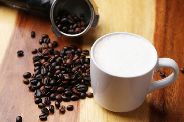 Hot latte , hot coffee and milk foam on wood floor