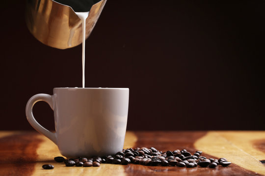 Hot latte , hot coffee and milk foam on wood floor