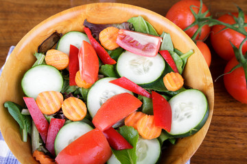 Large Mixed Salad in Wood Bowl with Fresh Tomatoes