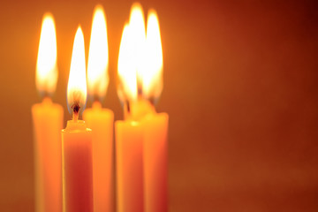 Group of still life  golden candle light with reflection on soft red blurred  background. Abstract background for pray or meditation caption and hope concept