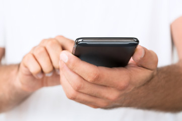 Close up of young man using smartphone with copy space