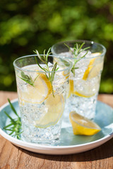refreshing lemonade drink with rosemary in glasses