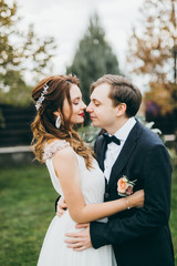 Elegant wedding couple in the autumn park