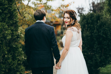 Elegant wedding couple in the autumn park