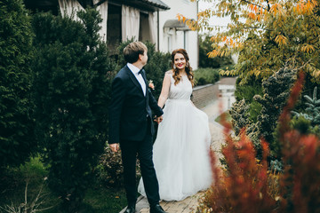 Elegant wedding couple in the autumn park