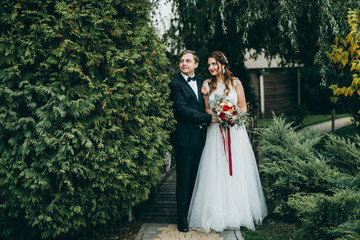 Elegant wedding couple in the autumn park