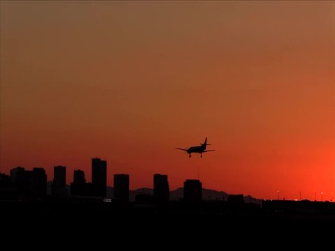 Small Private Jet Lands at Sunset at Phoenix Sky Harbor Airport