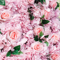 Fototapeta premium Pink fake flowers roses background. Close up, texture. Toned.