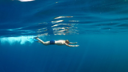 Fototapeta na wymiar swimmer in flippers dives into the sea