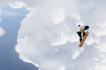 Fototapeta na wymiar Snowboarder making jump