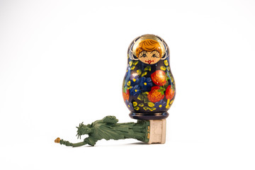 Russian babushka doll standing on top of the fallen Statue of Liberty
