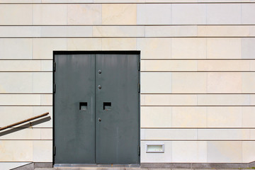 Obraz na płótnie Canvas Closed metal door in a stone wall