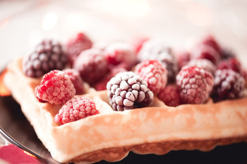 Tasty homemade waffle with fruits closeup. Selective focus. Summer dessert.