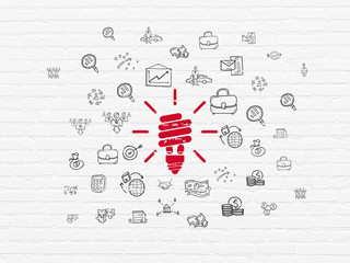 Finance concept: Energy Saving Lamp on wall background