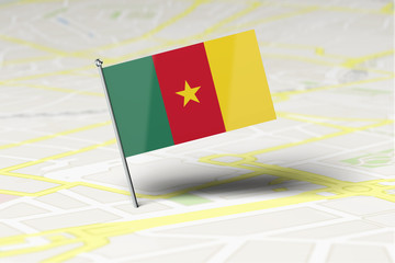 Cameroon national flag location pin stuck into a city road map. 3D Rendering
