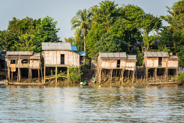 Huts on the riverbank at Burmese fishing village, Irrawaddy delta, near Yangon, Myanmar