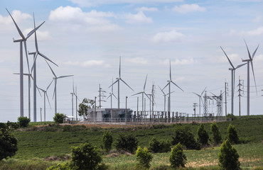 wind turbines generating electricity with high voltage electrical power substation for renewable wind energy