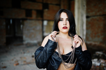 Brunette plus size sexy woman with earring in the nose, wear at black leather jacket, lace  bra at...