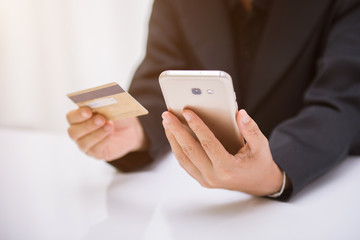 Women hold credit cards for online shopping. Internet purchase is popular because it is convenient, economical and secure.