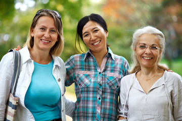 Three mature ladies smiling