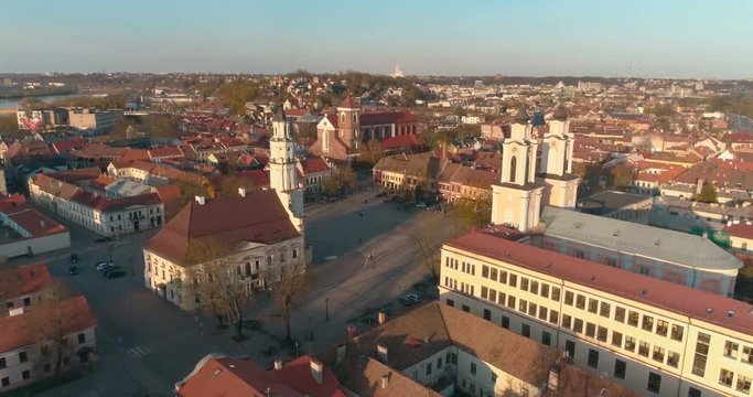 AERIAL. Drone shot through Church of St. Francis Xavier and Town Hall above square in Kaunas downtown, Lithuania Spring, 4k