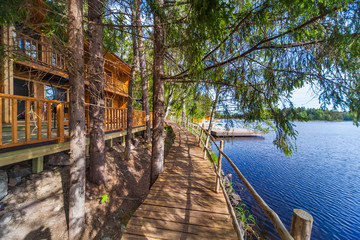Wooden paths near the lake in the spring forest of Karelia