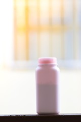 plastic bottle on white blurry background  in city. Using wallpaper for package work photo.