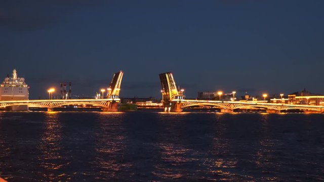 The ship sails through the drawbridge at night. Saint-Petersburg, Russia