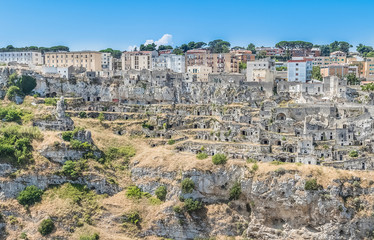 Fototapeta na wymiar panoramic view of typical stones (Sassi di Matera) of Matera UNESCO European Capital of Culture 2019 under blue sky. Basilicata