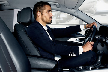 Handsome man in the car. Luxury life.