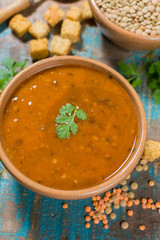 Homemade red lentils soup in yellow bowl