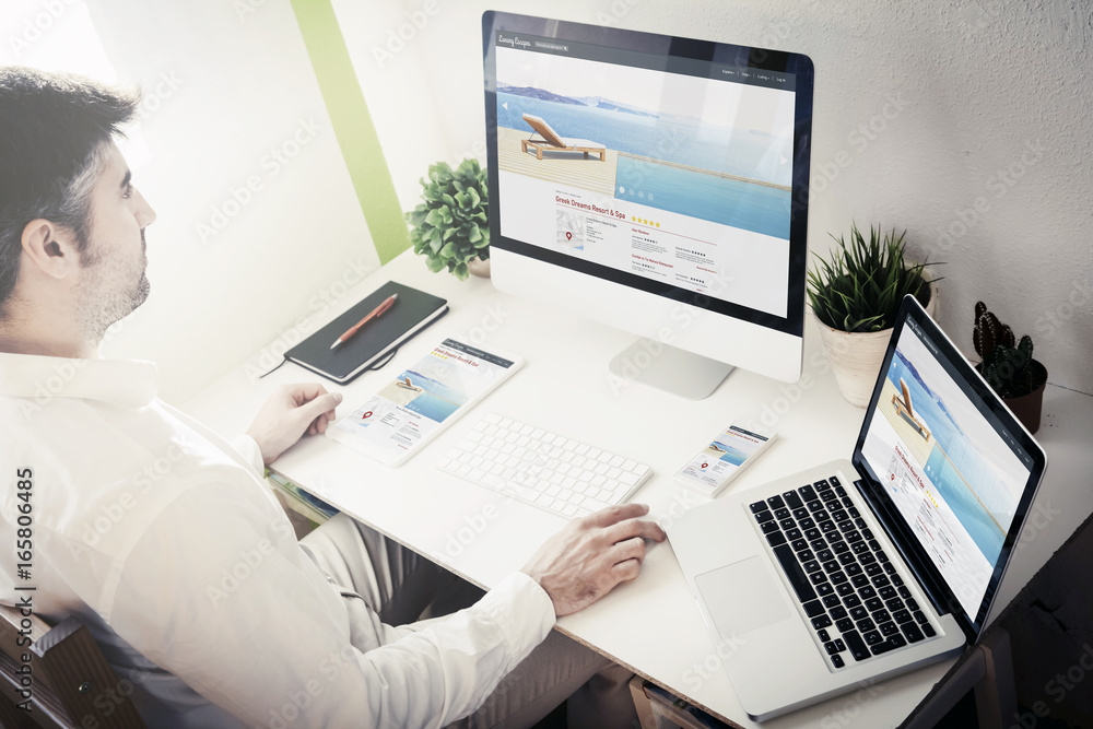 Poster man working with devices resort and spa responsive website